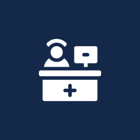 Nurse at reception desk icon on navy.